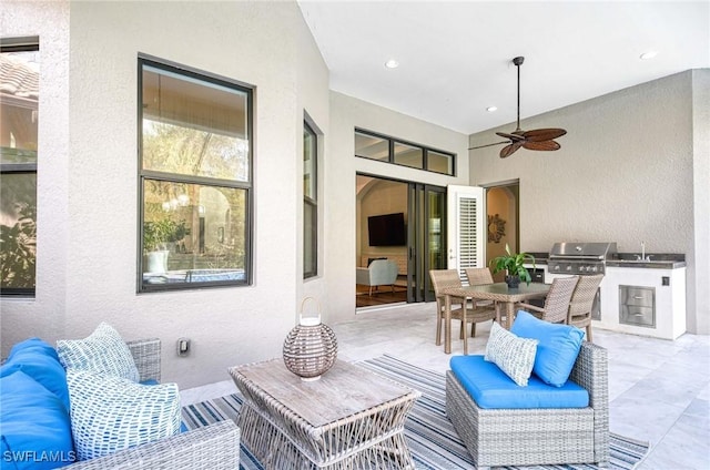 view of patio featuring sink, grilling area, ceiling fan, and exterior kitchen