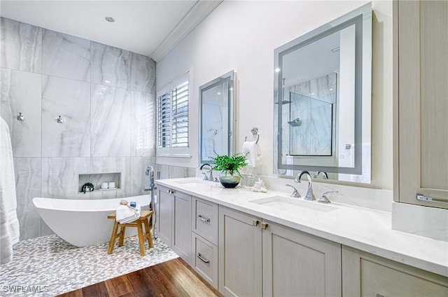 bathroom with vanity, hardwood / wood-style flooring, independent shower and bath, and tile walls