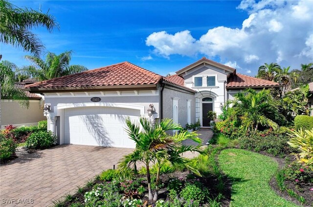 mediterranean / spanish-style home with a garage