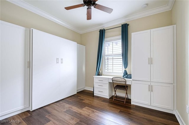 unfurnished office featuring ceiling fan, ornamental molding, and dark hardwood / wood-style flooring