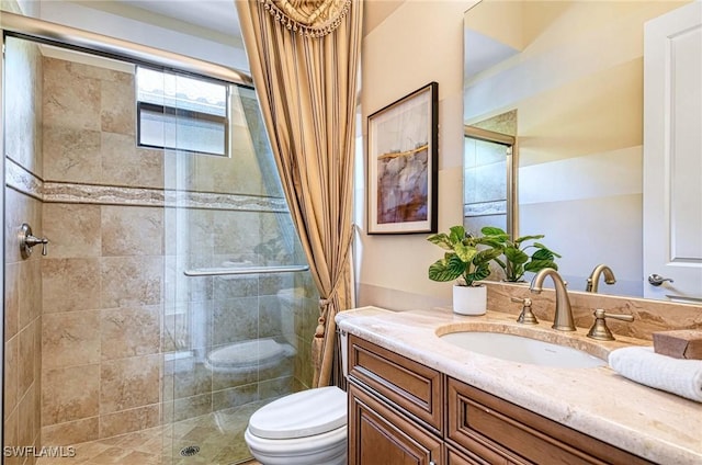 bathroom featuring walk in shower, vanity, and toilet