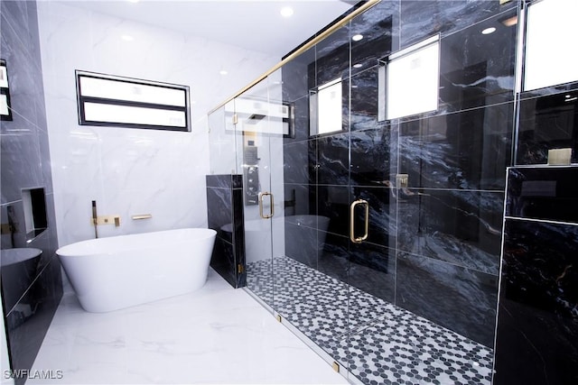 bathroom with shower with separate bathtub and tile walls