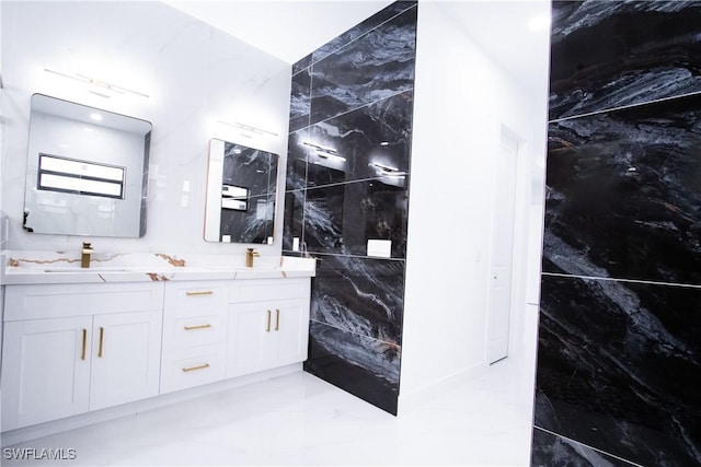 bathroom featuring vanity and tile walls