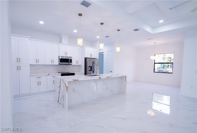 kitchen with white cabinetry, hanging light fixtures, light stone counters, and appliances with stainless steel finishes