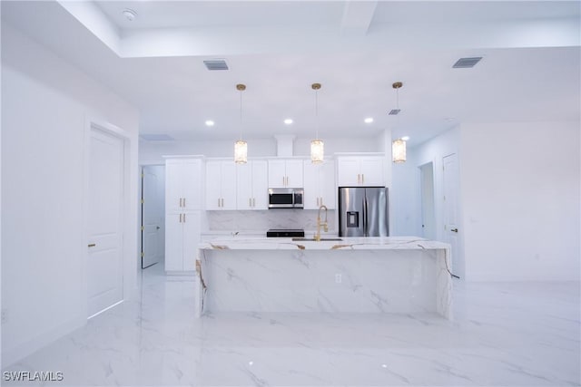 kitchen with light stone counters, pendant lighting, appliances with stainless steel finishes, and white cabinets