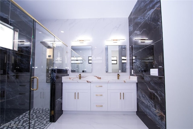 bathroom with vanity, tile walls, and a shower with shower door