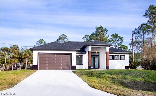 view of front of property with a garage and a front yard