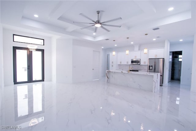 living room featuring french doors, ceiling fan, and a raised ceiling