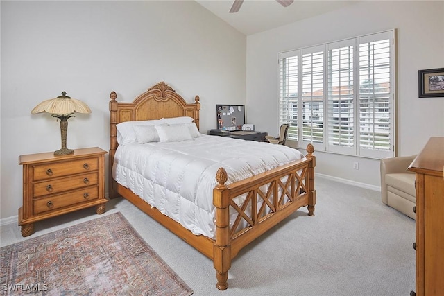 bedroom with light colored carpet, baseboards, and ceiling fan