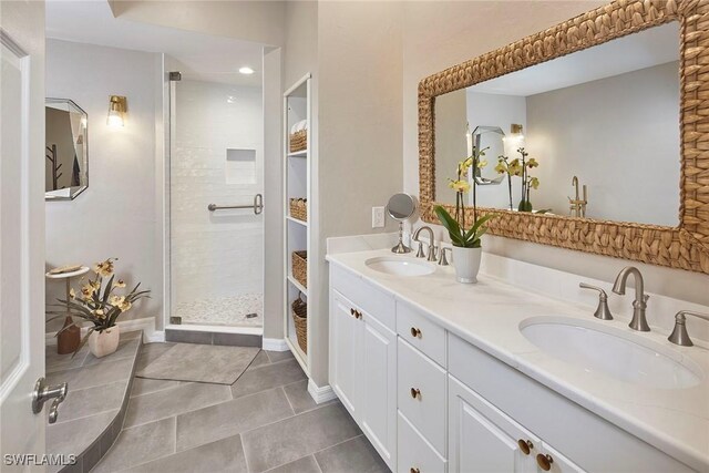 bathroom featuring a shower stall, tile patterned floors, double vanity, baseboards, and recessed lighting