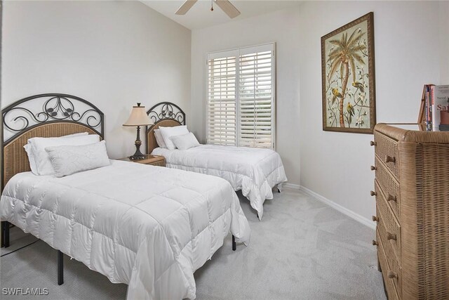 carpeted bedroom featuring baseboards and ceiling fan