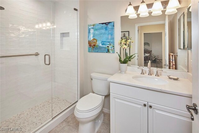 full bath with toilet, a shower stall, vanity, and tile patterned floors