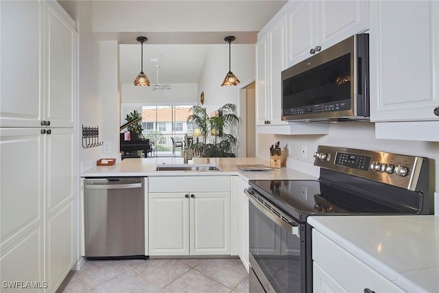 1033 Egrets Walk Cir Unit 203, Naples, FL 34108 - kitchen with appliances with stainless steel finishes, white cabinetry, light tile patterned floors, pendant lighting, and lofted ceiling