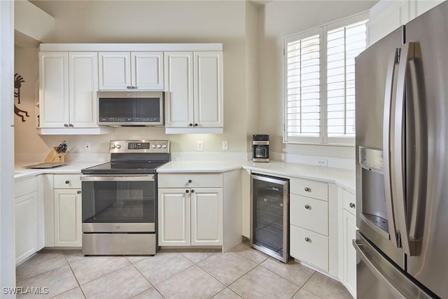 1033 Egrets Walk Cir Unit 203, Naples, FL 34108 - kitchen featuring appliances with stainless steel finishes, beverage cooler, light countertops, and healthy amount of natural light