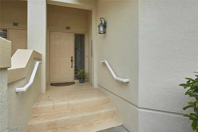 1033 Egrets Walk Cir Unit 203, Naples, FL 34108 - view of exterior entry with stucco siding