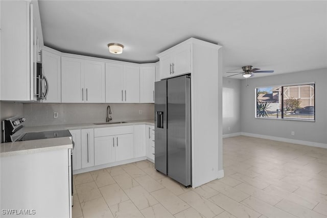 kitchen featuring white cabinetry, appliances with stainless steel finishes, sink, and tasteful backsplash