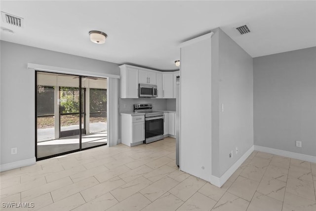 kitchen with stainless steel appliances and white cabinetry