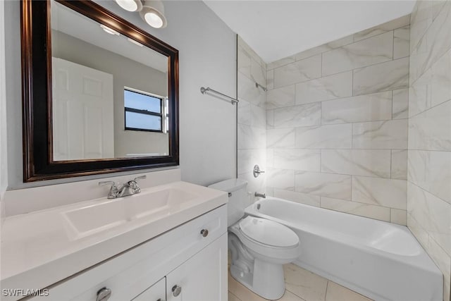 full bathroom featuring tiled shower / bath, vanity, and toilet