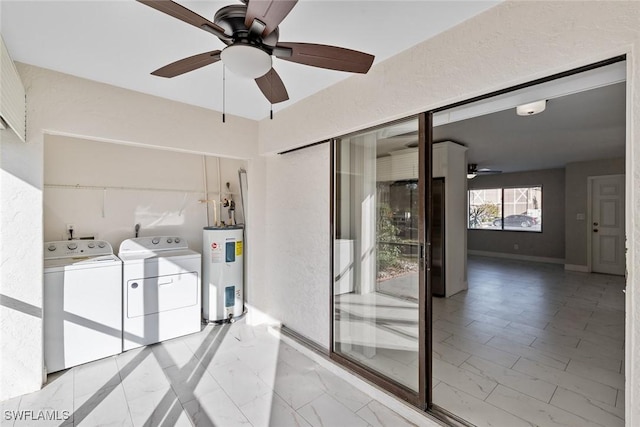 washroom with ceiling fan, washing machine and dryer, and water heater