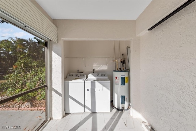 washroom featuring electric water heater and washer and dryer