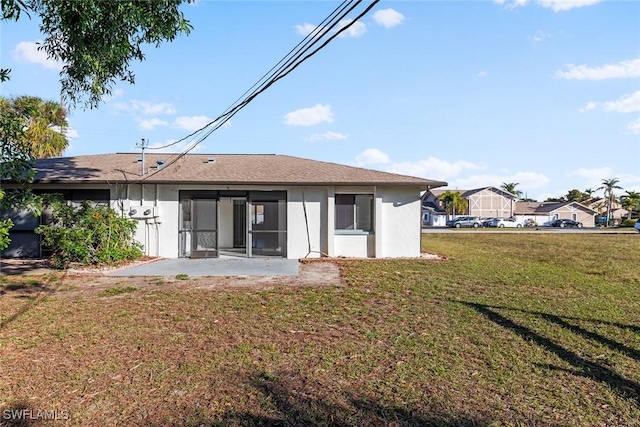 back of property with a patio area and a lawn