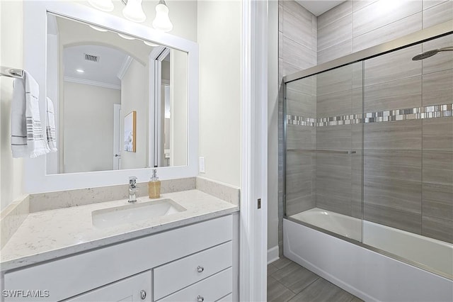 bathroom with ornamental molding, combined bath / shower with glass door, and vanity