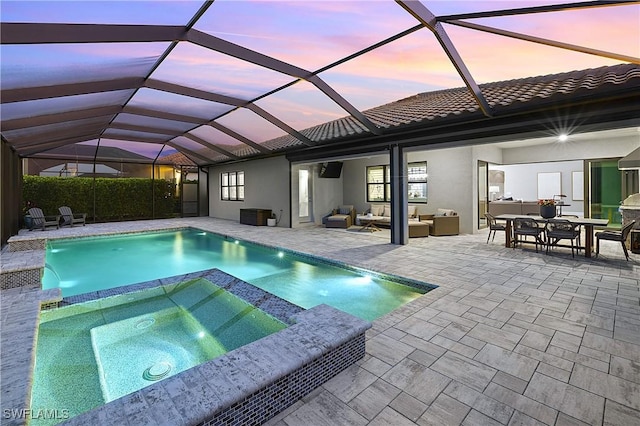 view of pool featuring an outdoor living space, a lanai, a patio, and an in ground hot tub