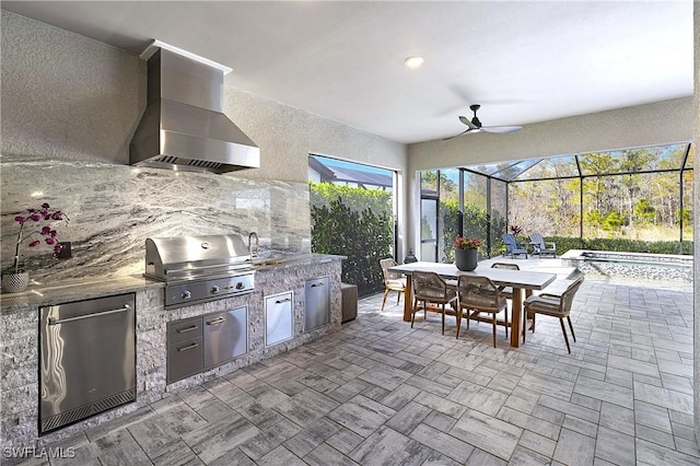 view of patio with an outdoor kitchen, a ceiling fan, area for grilling, a lanai, and outdoor dining space