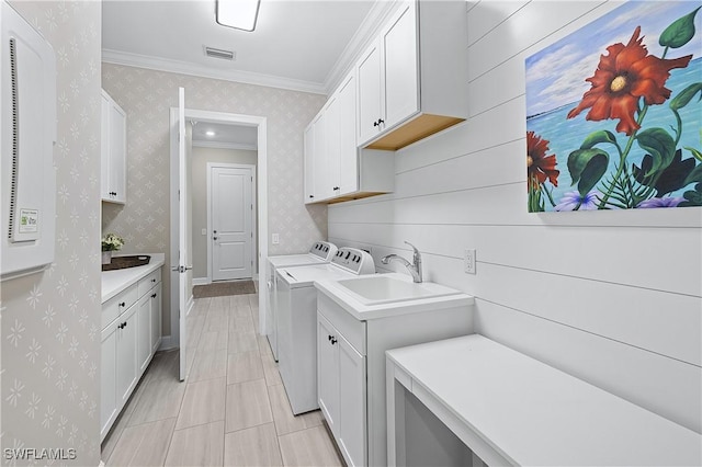 laundry area featuring wallpapered walls, cabinet space, visible vents, ornamental molding, and washer and dryer