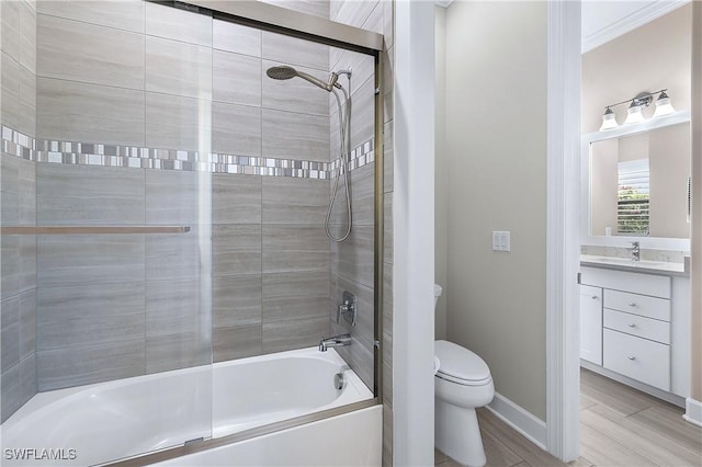 bathroom featuring shower / bath combination, vanity, toilet, and baseboards