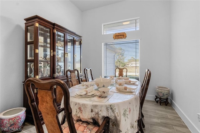 dining space with light wood-style floors and baseboards