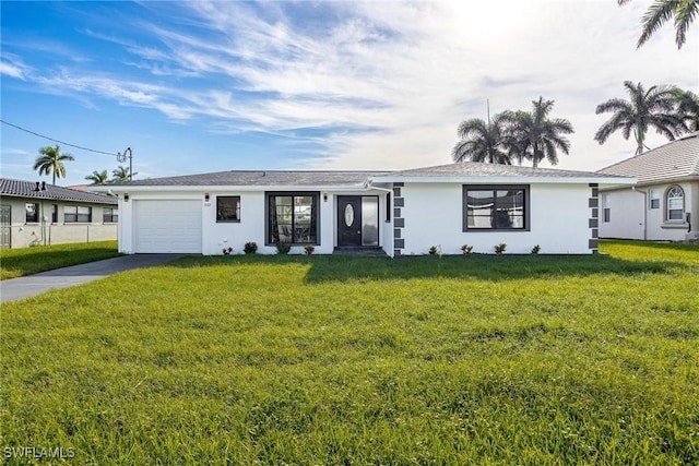 single story home featuring a garage and a front yard