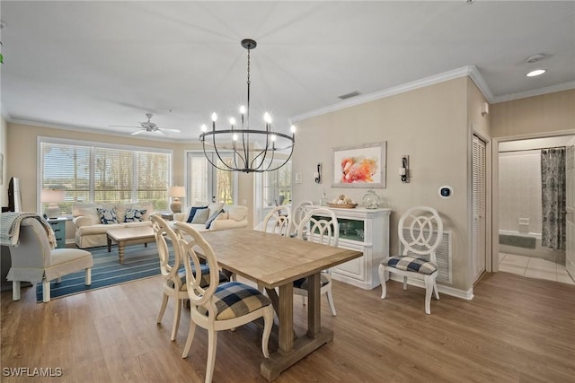 dining area featuring crown molding and light hardwood / wood-style floors