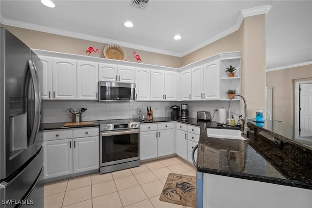 kitchen featuring sink, light tile patterned floors, stainless steel appliances, ornamental molding, and white cabinets