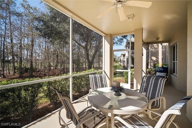 sunroom featuring ceiling fan