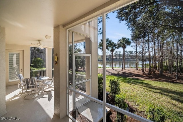 sunroom featuring a water view and a wealth of natural light