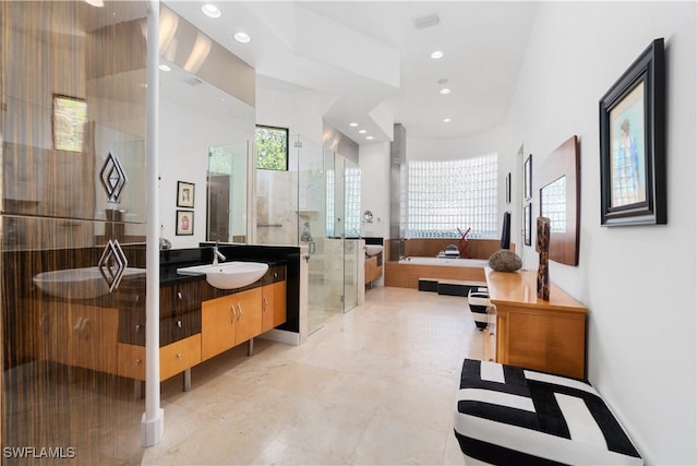 bathroom featuring plus walk in shower and vanity