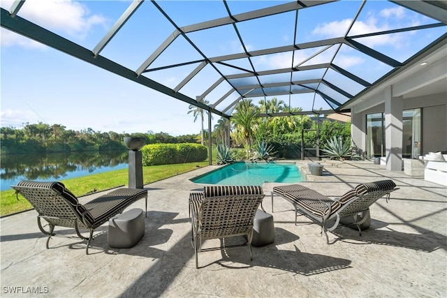 view of swimming pool with a lanai, a patio area, and a water view