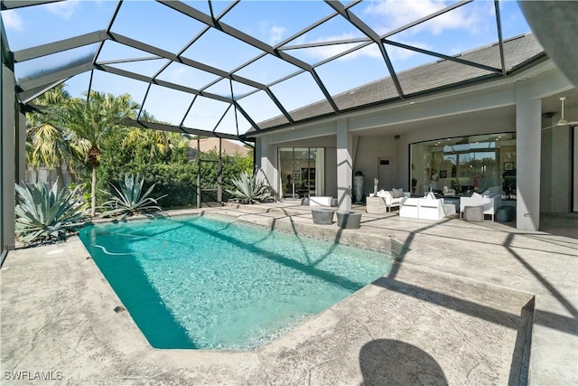 view of pool with pool water feature, an outdoor hangout area, glass enclosure, and a patio area