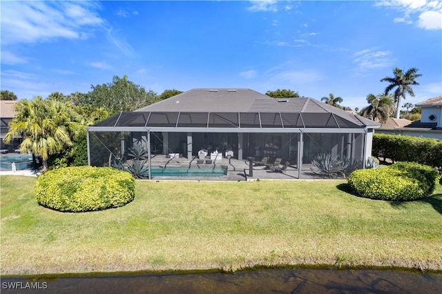 back of house with a yard, a patio area, and glass enclosure