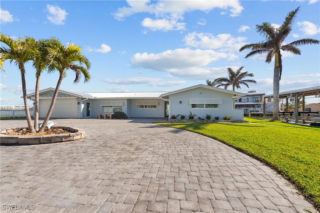 ranch-style home featuring a garage and a front yard