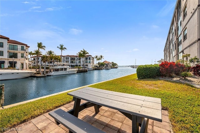 view of property's community featuring a water view and a yard