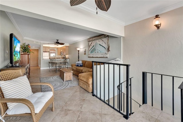 living room with crown molding, light tile patterned floors, and ceiling fan