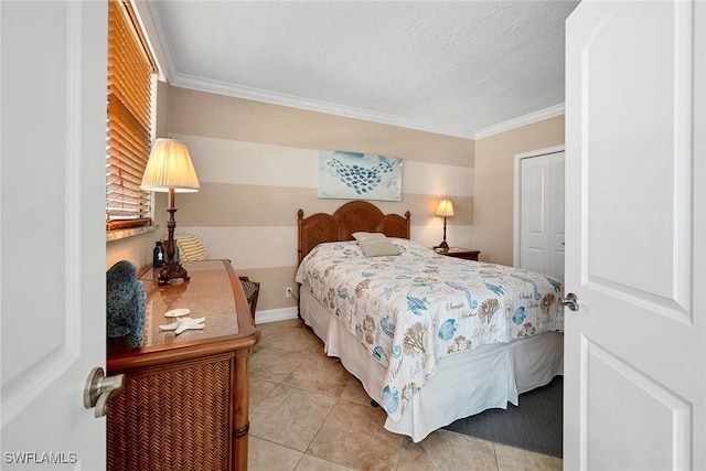 bedroom featuring crown molding, light tile patterned flooring, and a closet