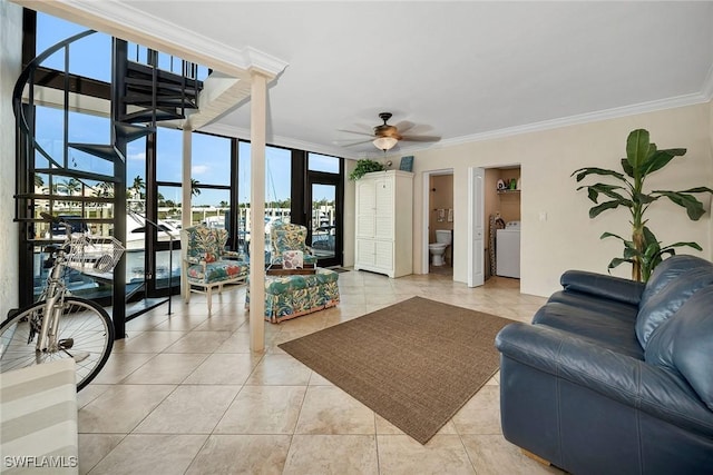 living room with ceiling fan, ornamental molding, washer and clothes dryer, and light tile patterned floors