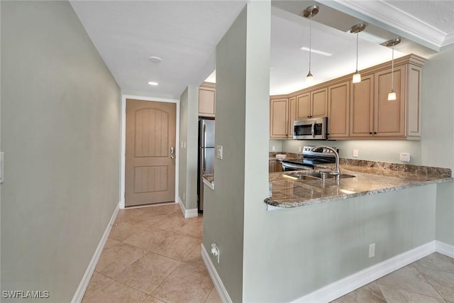 kitchen with sink, appliances with stainless steel finishes, kitchen peninsula, pendant lighting, and light stone countertops