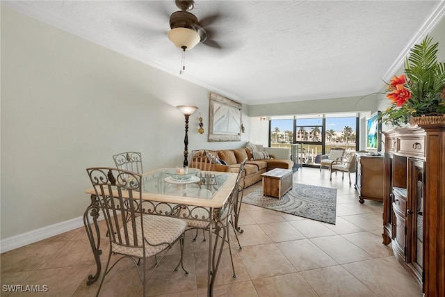 dining area with crown molding, ceiling fan, light tile patterned flooring, and a textured ceiling