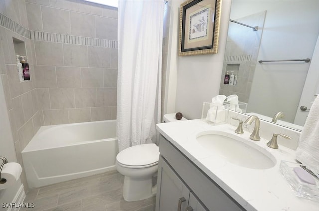 full bathroom with vanity, shower / bath combo, and toilet