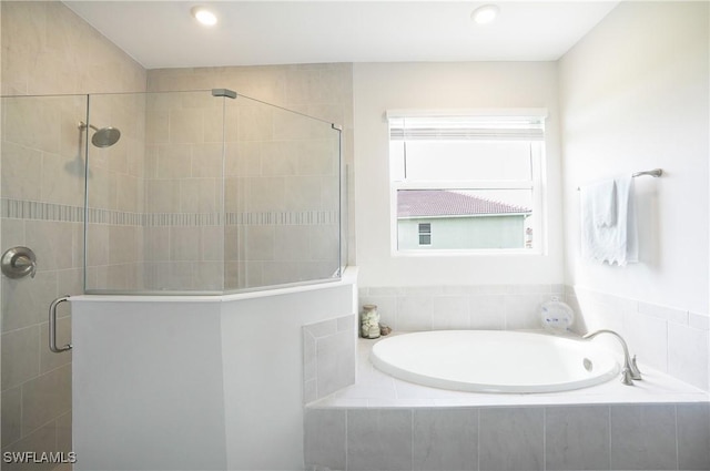 bathroom featuring separate shower and tub