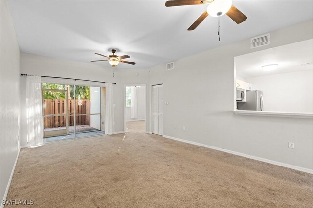 spare room featuring ceiling fan and carpet flooring